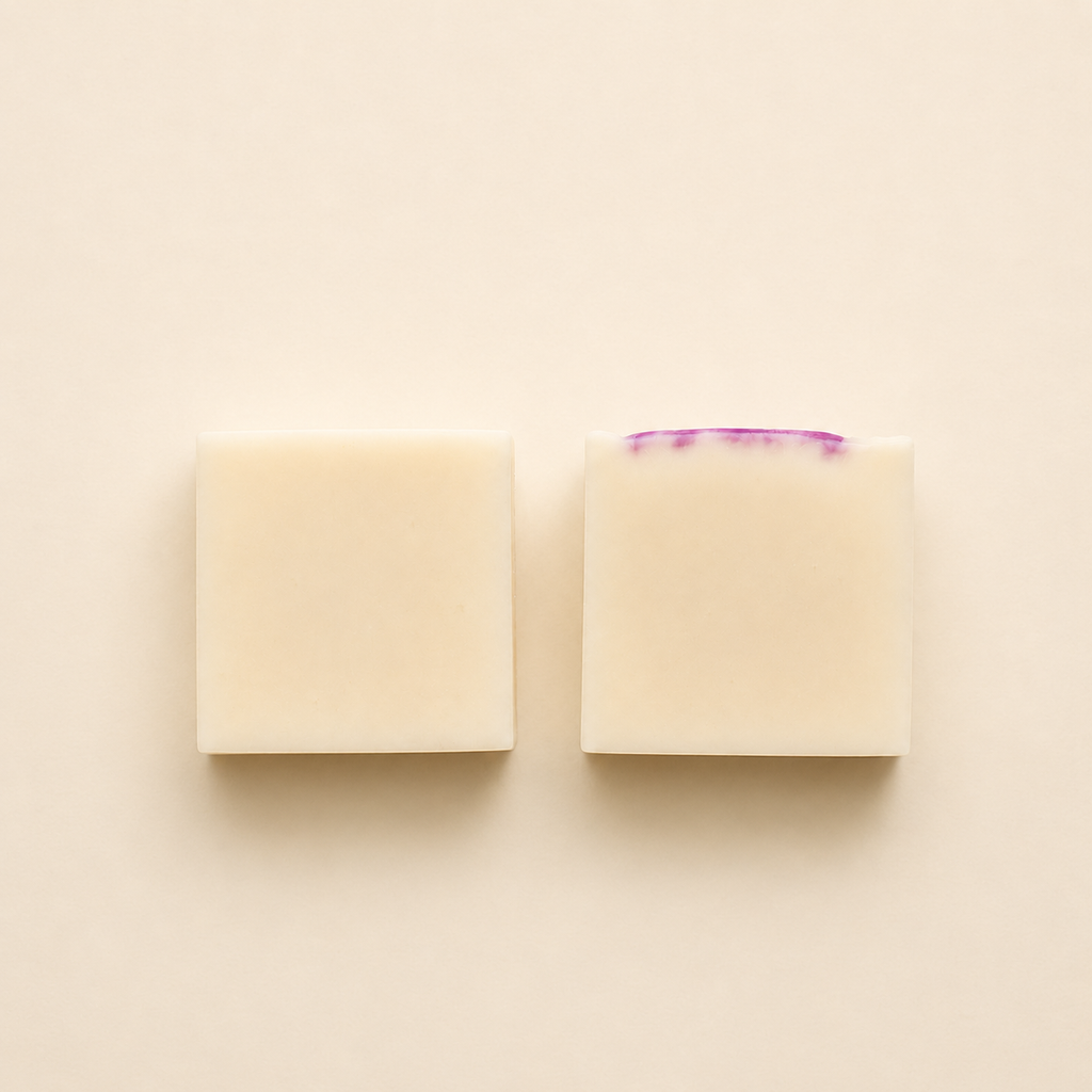Handmade artisan soap bars with a creamy ivory finish, displayed in a minimalist flat lay composition on a soft neutral background.