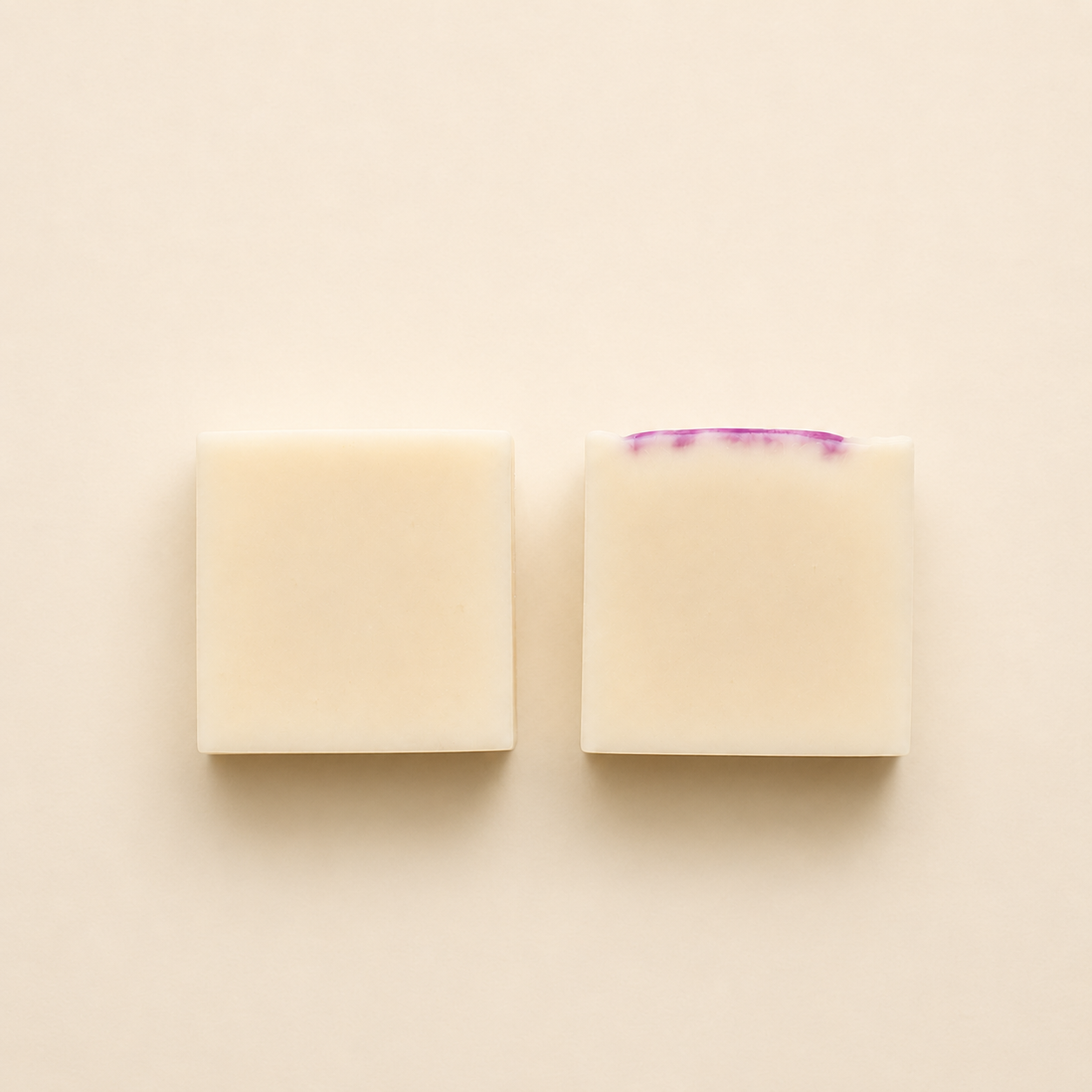 Handmade artisan soap bars with a creamy ivory finish, displayed in a minimalist flat lay composition on a soft neutral background.